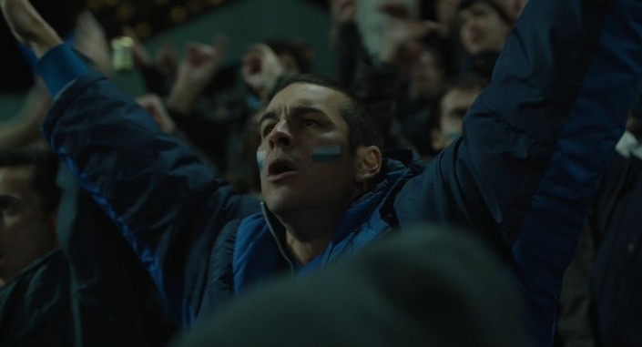Mario Casas as Sergio cheering at a football match in AWAY.