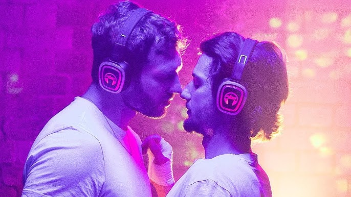 Romantic scene from A Night Like This featuring two men sharing an intimate moment in a colorful nightclub setting.