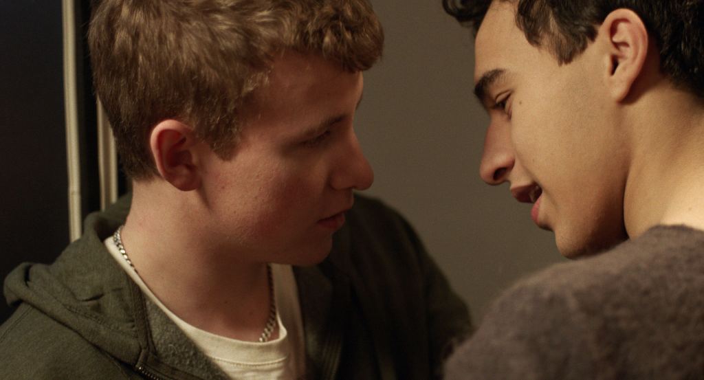 Oskar and Ahmad share an intimate moment aboard an overnight train in The Night Train, Jerry Carlsson's award-winning LGBTQ romantic short film.