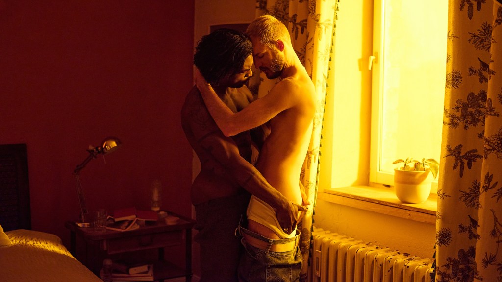 Sagat and Roman share an intimate moment in the gay film REMEMBER I AM DEAD