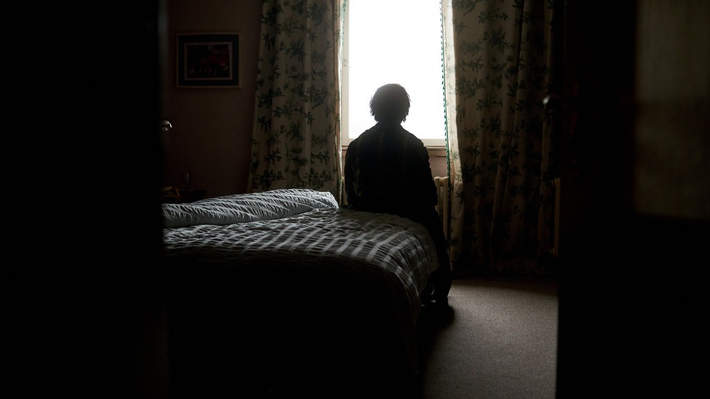 Roman sits alone in a darkened bedroom in Noel Alejandro’s REMEMBER I AM DEAD