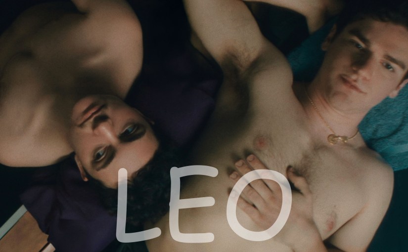 Two shirtless young men lie closely together beneath the title LEO, a gay short film streaming on Dekkoo.
